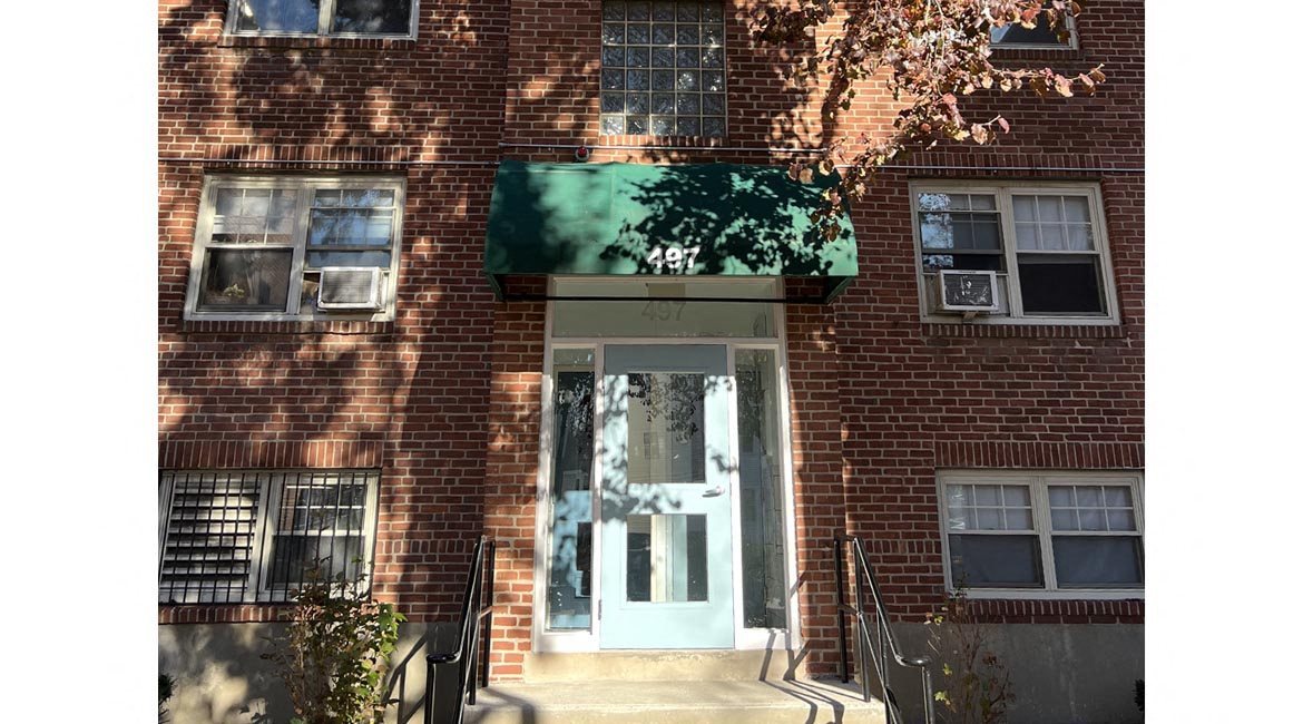 Brick building on tree-lined street